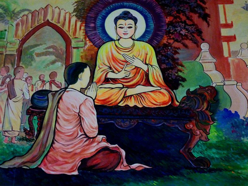 Wandbild: eine kniende Frau vor dem sitzenden Buddha